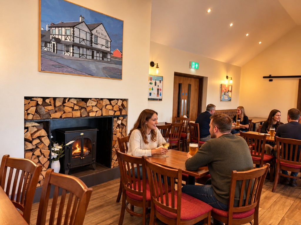 The dining room, with a fireplace and tables set for guests